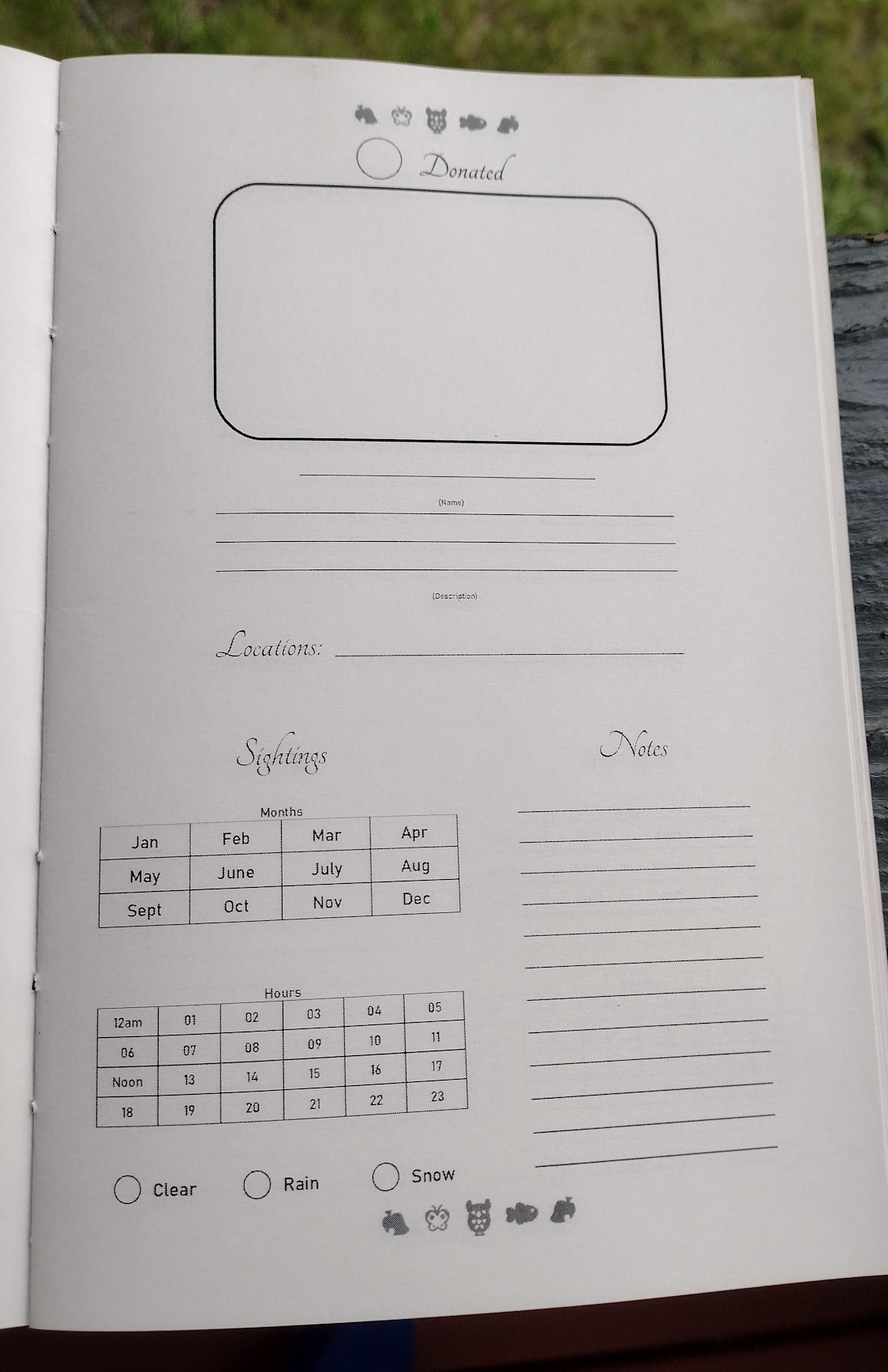 A photo of a blank journal page. At the top is a box for drawing in. Below that are lines for the creature's name, a description, and where it can be found. The lower left has a set of boxes where you can mark which months and which hours the creature can be found. The lower right has a small section for notes.